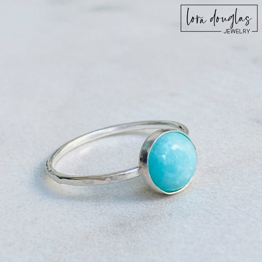 A sterling silver ring with a blue amazonite stone, set in a classic bezel setting.