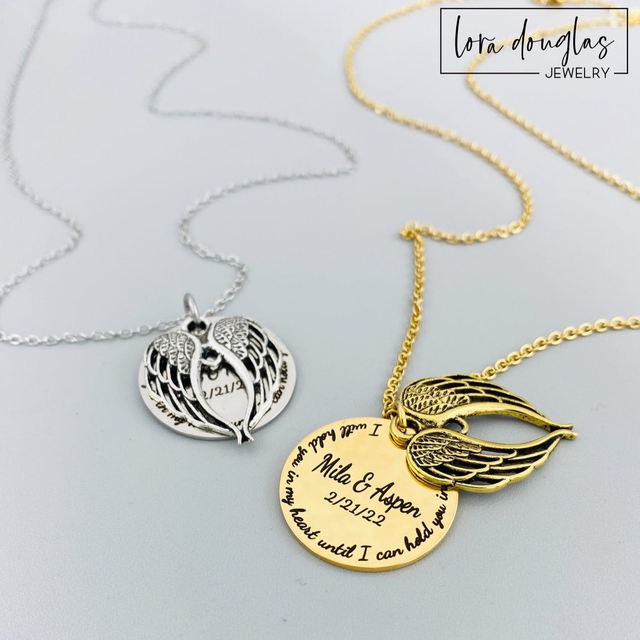 Two stainless steel memorial necklaces with swing lockets. One has a silver finish and the other has a gold tone. Angel wing charm necklace.