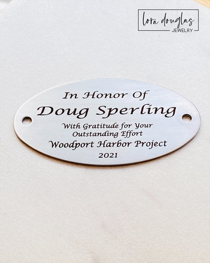 This engraved memorial plaque offers a timeless way to honor loved ones or commemorate special moments. Crafted for clarity and durability, it serves as a meaningful dedication on benches or other surfaces. Please note that hardware for mounting is not included, allowing you to select the best option for your installation needs. Ideal for personalized tributes, this plaque combines craftsmanship with lasting remembrance.