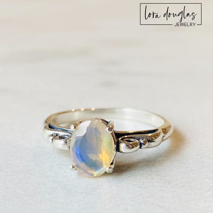 A sterling silver ring with a central opal stone