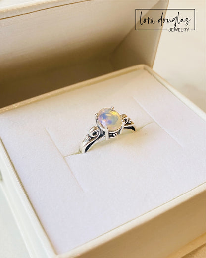 A sterling silver ring with a central opal stone