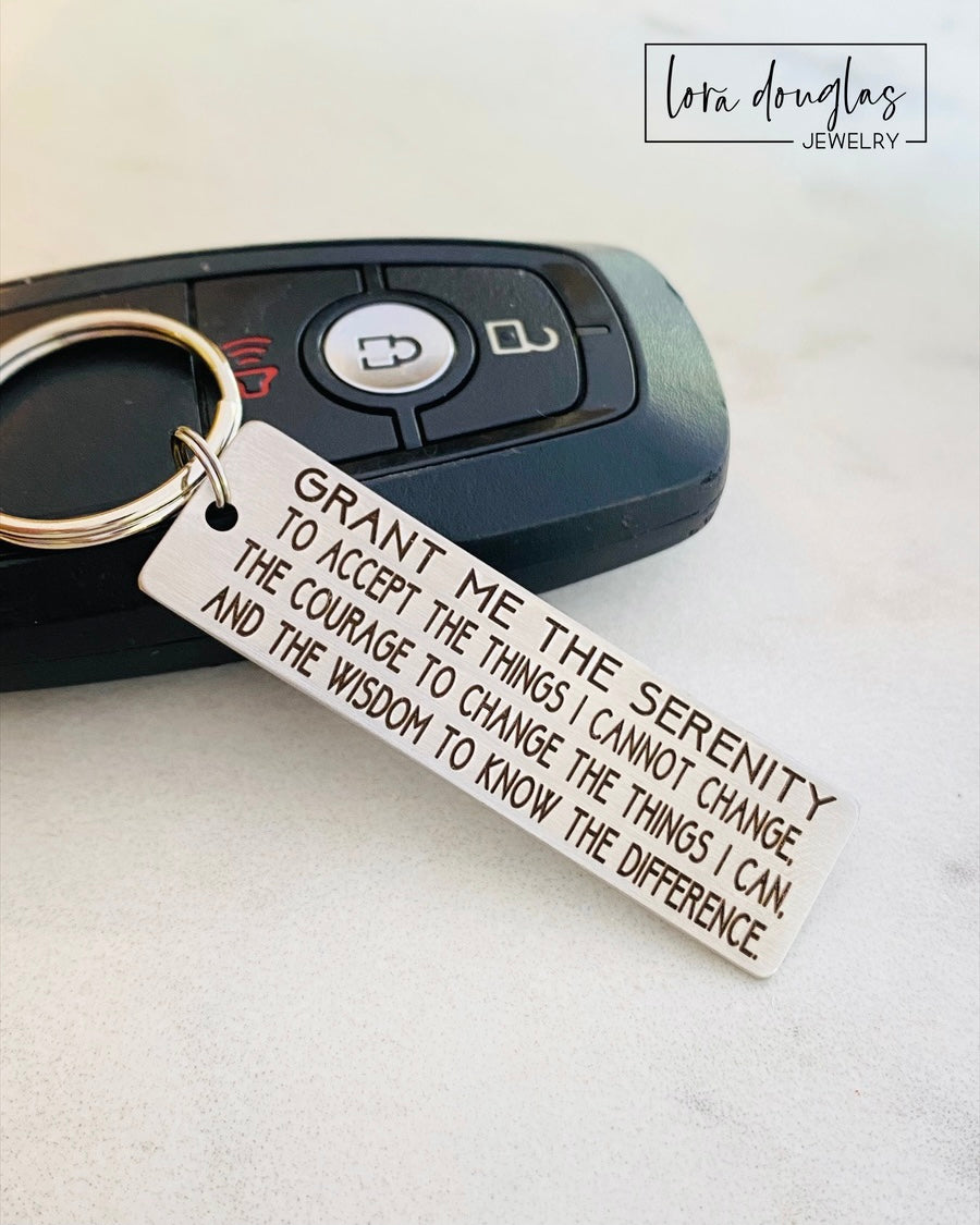 Engraved metal Serenity Prayer keychain with stainless steel construction and permanent laser etched lettering. Rectangular plaque with standard key ring offers customizable two sided engraving and durable everyday use, perfect as a recovery support gift, motivational token, or inspirational personalized keychain.