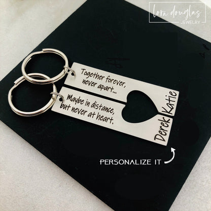 A stainless steel heart-shaped keychain with engraved text 'Together Forever Never Apart Maybe in Distance but Never at Heart' The keychain is silver-colored and has a personalized engraving.
