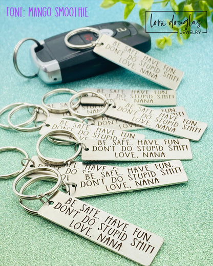 A stainless steel keychain with a laser engraved personalized message. The keychain has a rectangular tag with an example of custom text that can be added, indicating it is a personalized product.