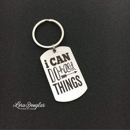 stainless steel keychains with the engraved text 'I CAN DO HARD THINGS' on a black background.
