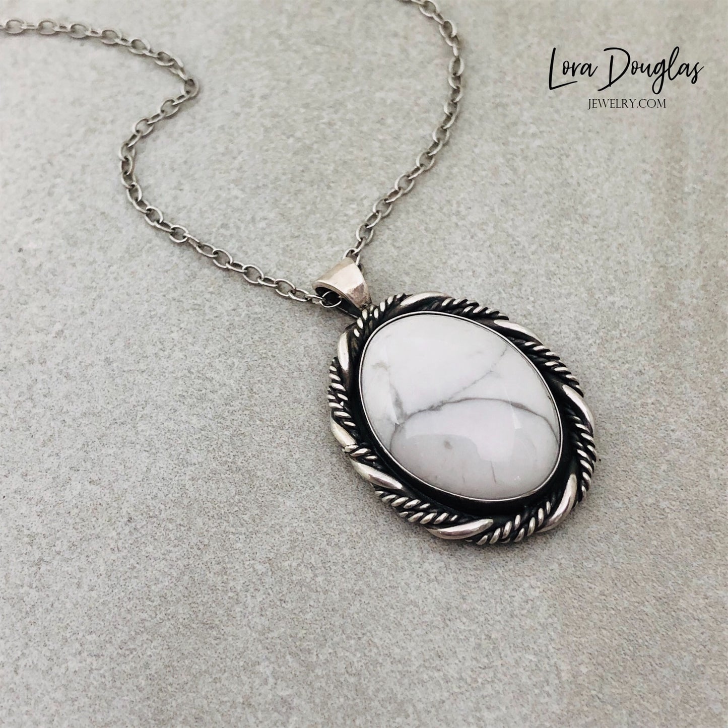 A sterling silver pendant necklace with a white howlite stone set in a silver setting, attached to an 18-inch sterling silver chain with a C clasp.