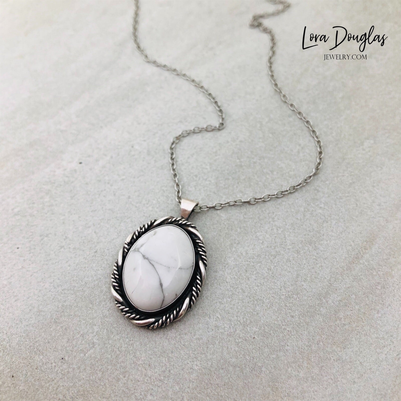 A sterling silver pendant necklace with a white howlite stone set in a silver setting, attached to an 18-inch sterling silver chain with a C clasp.