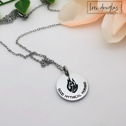 Three custom jewelry charms with engraved logos on a disc-shaped pendant, attached to different types of jewelry including a necklace and a bracelet, with the option to engrave your logo.