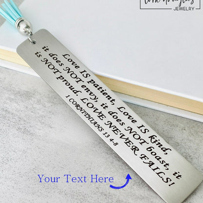 personalized bible verse bookmark engraved with custom scripture on stainless steel metal bookmark with leather tassel, christian bookmark gift displayed inside open Bible with permanent laser engraved verse detail