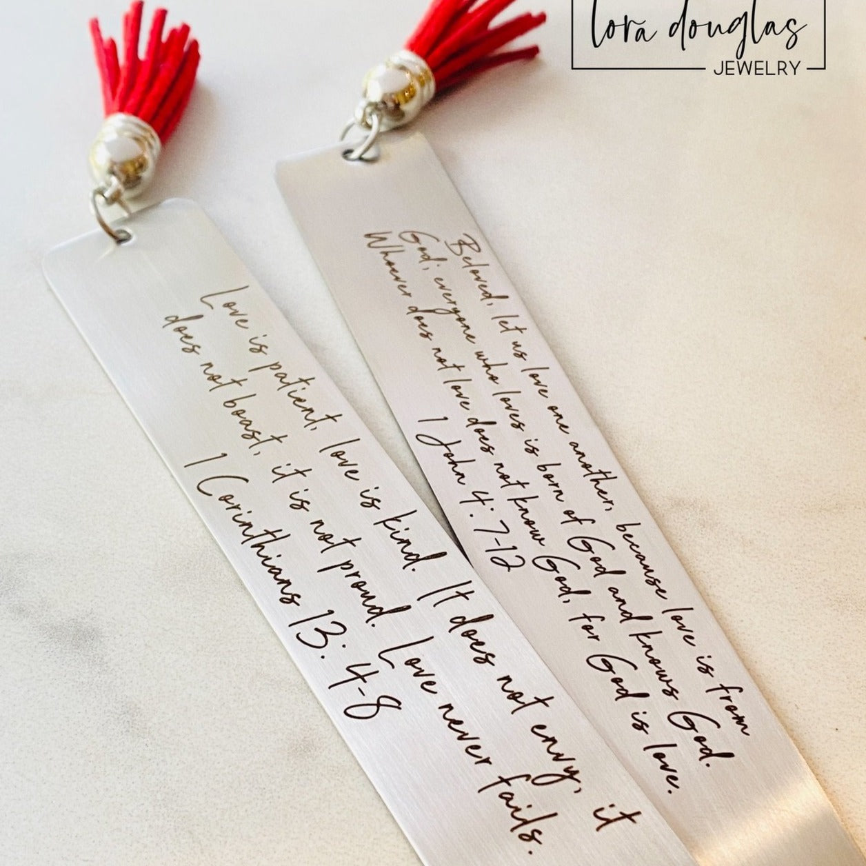 personalized bible verse bookmark featuring engraved scripture and leather tassel displayed beside Bible pages, stainless steel christian bookmark gift with permanent dark laser engraving and brushed silver finish