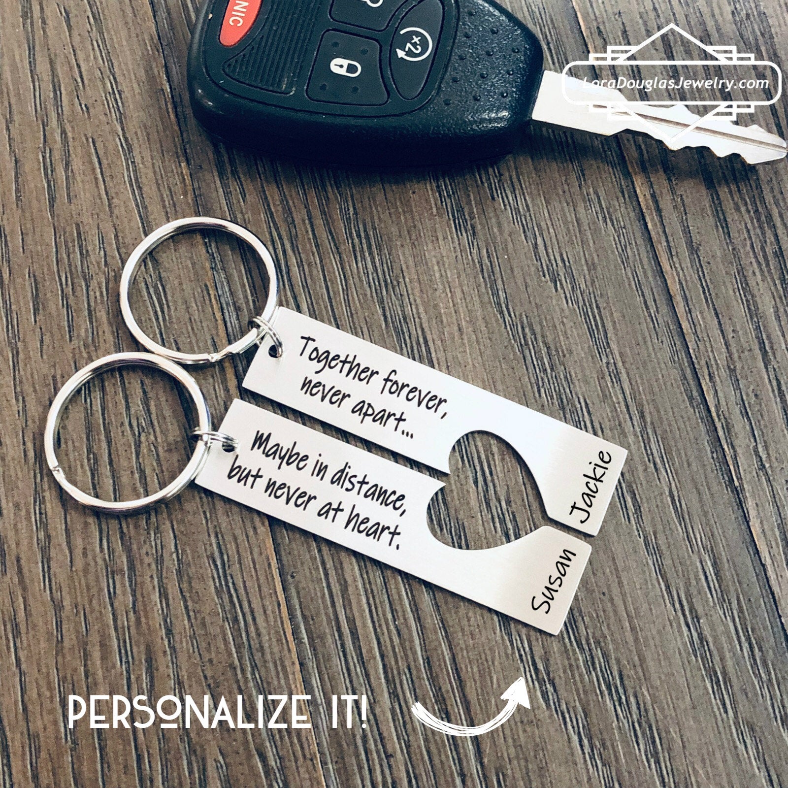 A stainless steel heart-shaped keychain with engraved text 'Together Forever Never Apart Maybe in Distance but Never at Heart' The keychain is silver-colored and has a personalized engraving.