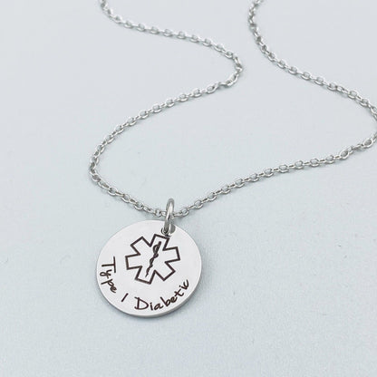 stainless steel personalized medical alert necklace with engraved medical symbol and custom wording shown on delicate chain, minimalist medical ID pendant suitable for allergies diabetes epilepsy and emergency contact details